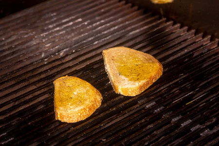 Tasty fresh bread being baked on charcoal grill.