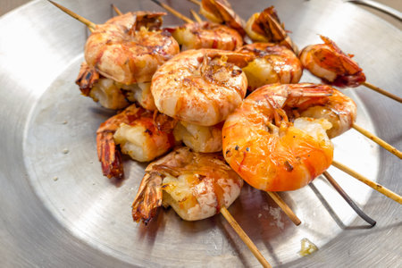 Grilled prawns on wooden skewers, shrimp kebab.の写真素材