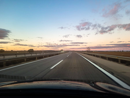 Sunset on the highway. View from the driver's seat.の写真素材