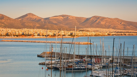 Boats in Mikrolimano marina  Evening scenery with city of Athens in the background の写真素材