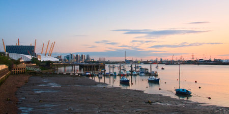 Boats on river Thames and O2 arena in the distance 