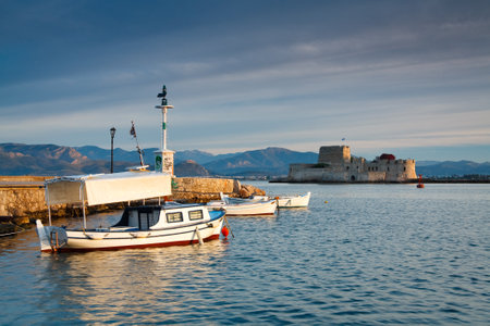 Fishing boats in Nafplio harbour and Bourtzi castle, Greece.のeditorial素材