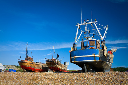 Boats on a beach in Hastings, UK.の写真素材