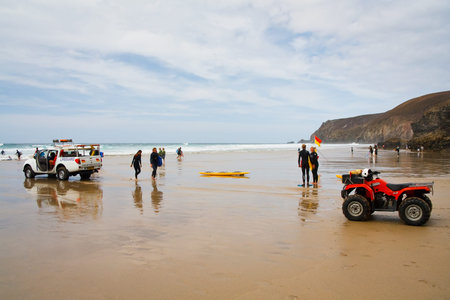 Lifeguard patrolling a beach at Porthtowan in Cornwall, UKのeditorial素材