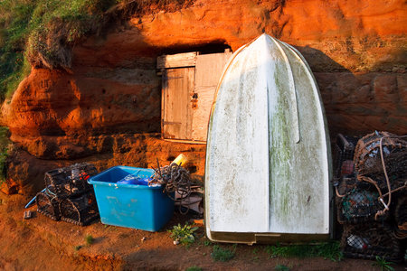 Fishing boat and crab cages in Ladram Bay, Devon, UK.の写真素材