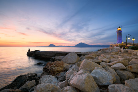 Fishermen near lighthouse in Patras Greeceのeditorial素材