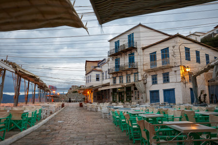 Terraces of coffee shops on the quay in the harbour of Hydraのeditorial素材