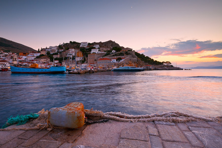 Boats mooring along a pier in harbour of Hydra.の写真素材