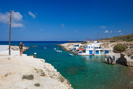Tourist taking photos of traditional boat houses in Mytakas, Milos island, Greeceのeditorial素材