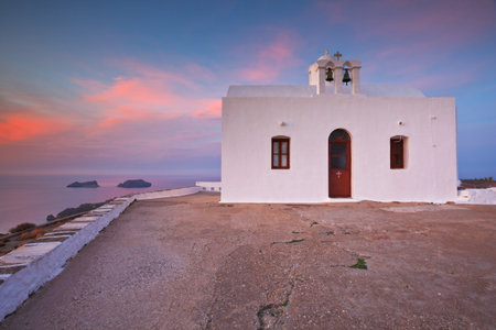 Church atop a hill over Plaka village, Milos island, Greece.の写真素材