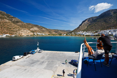 People on the deck of a ferry during a stop-over in the port of Kamares in Sifnos island, Greeceのeditorial素材