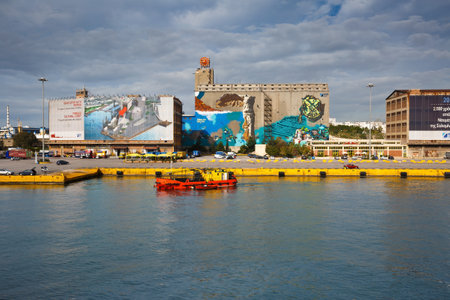 Oil and debris skimmer in at the buildings of a proposed museum in passenger port of Piraeus, Athens, Greeceのeditorial素材