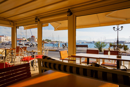 Coffee shop at the seafront of Aegina town with view of the harbour, Greeceのeditorial素材
