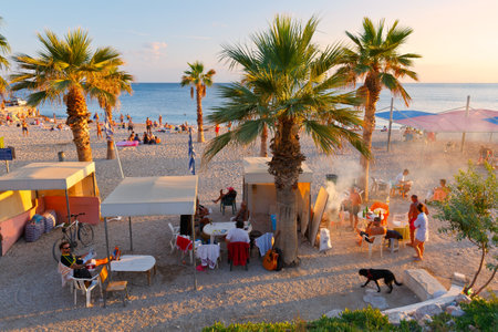 People having a barbecue on the beach in Palaio Faliro neighborhood in Athens.のeditorial素材