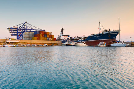Small harbour with fishing boats and motor boats between terminal 3 of the container port and shipyards of Perama.のeditorial素材