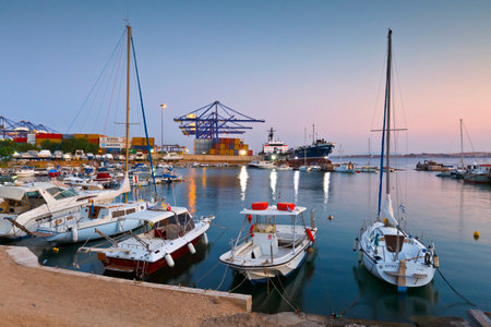 Small harbour with fishing boats and motor boats between terminal 3 of the container port and shipyards of Perama.のeditorial素材