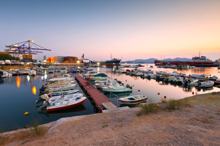 Small harbour with fishing boats and motor boats between terminal 3 of the container port and shipyards of Perama.のeditorial素材