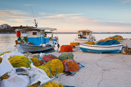 Fishing boats and nets in the port of Tinos.のeditorial素材