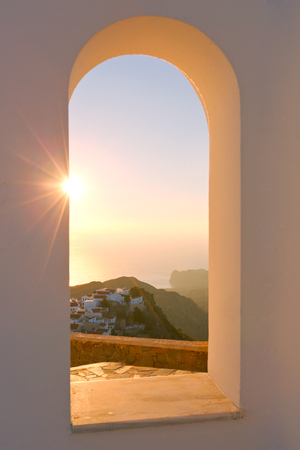 View of Nikia village through an arch of a church, Nisyros island.の写真素材