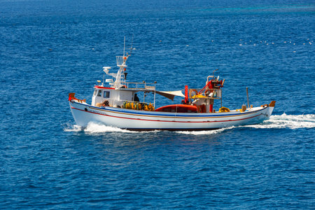 Traditional fishing boat in the open sea near Adamantas village, Milos island.のeditorial素材