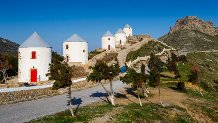 Rebuilt traditional windmills on a hill above Panteli village on Leros island, Greece.のeditorial素材