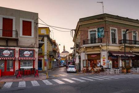 Shops in the city centre of Chios town and Turkish mosque in the background.のeditorial素材