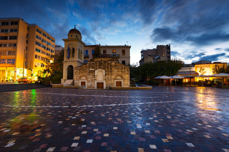 Greek orthodox church amd coffee shops in Monastiraki square in Athens, Greece.のeditorial素材