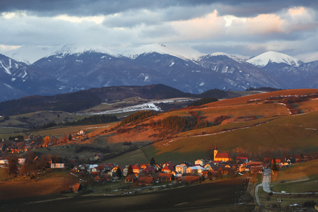 Village in Turiec region with view of Mala Fatra mountain range in winter.の写真素材