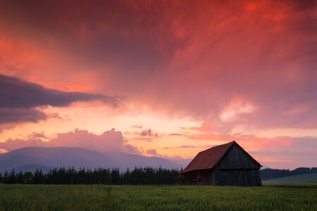 Rural landscape with a traditional barn in Turiec region, central Slovakia.の写真素材
