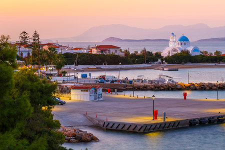 Skala, Greece - November 02, 2019: Harbour and a church in Skala village on Agistri island, Greece.のeditorial素材