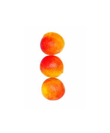 Three apricots vertically isolatedの写真素材