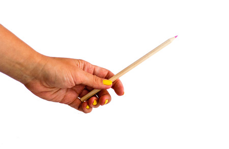 Woman`s hand holding pink pencilの写真素材
