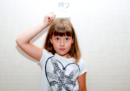 Little girl with card sign help messageの写真素材