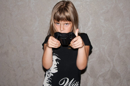 Girl in black clothes with joystick in hands