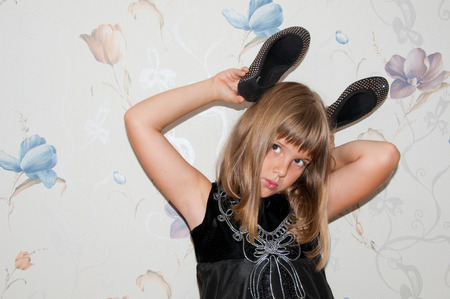 Girl poses with pair of black shoesの写真素材