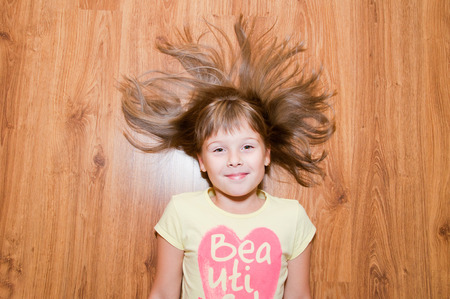Younger girl on the floor nice smilesの写真素材