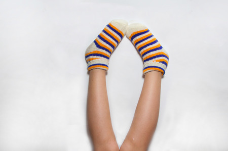 Girl`s legs in funny striped socks upの写真素材