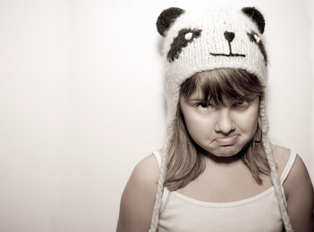 Girl in knitted cat hat pose a faceの写真素材