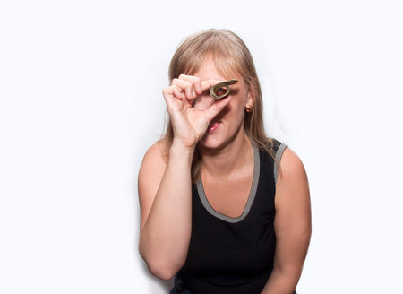 Young woman with dollars in hands smiles isolated