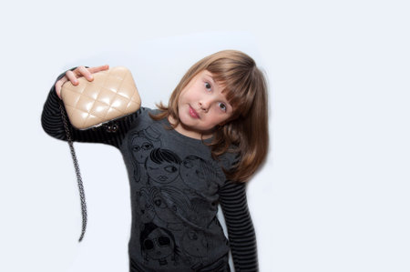 Teen girl with clutch in hand isolatedの写真素材