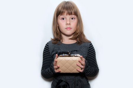 Teen girl with clutch in hand isolatedの写真素材