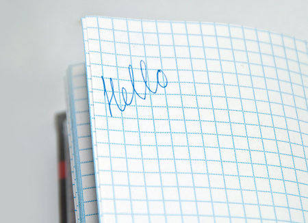 Blue ink Lettering hello in a notebook