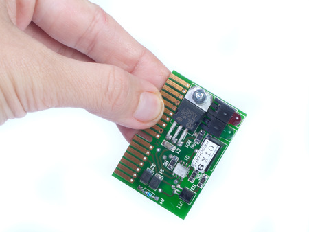 mini chip board in fingers isolated whiteのeditorial素材