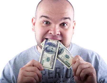 Mad man eats dollar bills portrait isolated whiteの写真素材