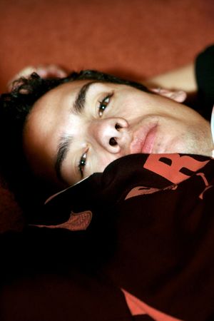 a young man laying on the floorの写真素材