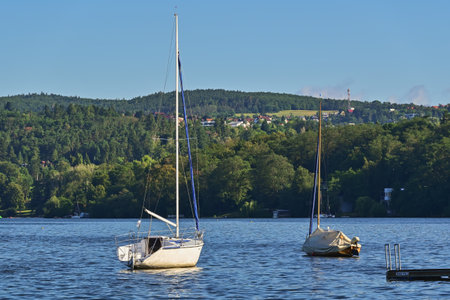 Sailboats in harbor on lake in sunny morningの写真素材