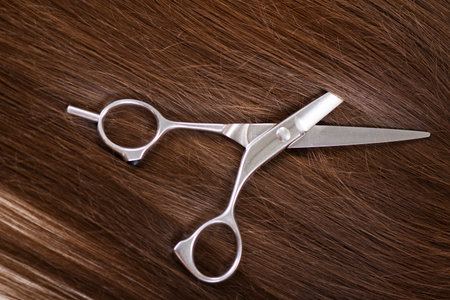 Beautiful healthy shiny hair and professional scissors 