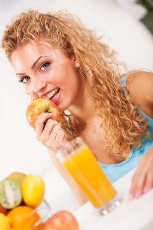 Beautiful young woman with fruitsの写真素材