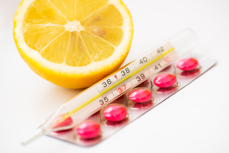 Medical thermometer, pills and lemonの写真素材