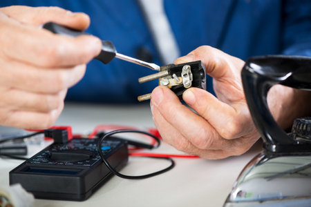 Electrician checking and repairing old power plug from iron  Close-up  Selective focus, Focus on...
